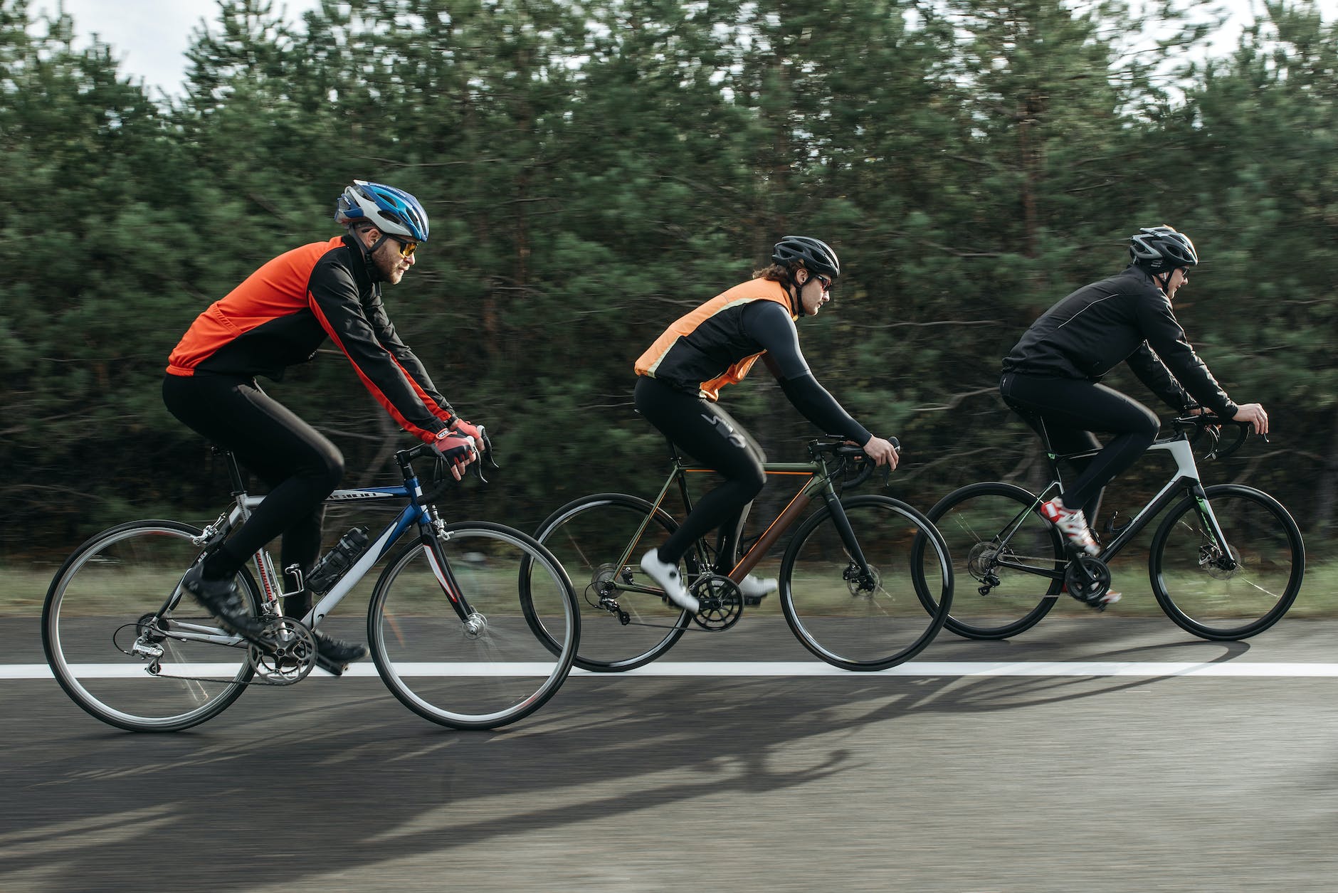 men riding bicycles on the road for MTB training program