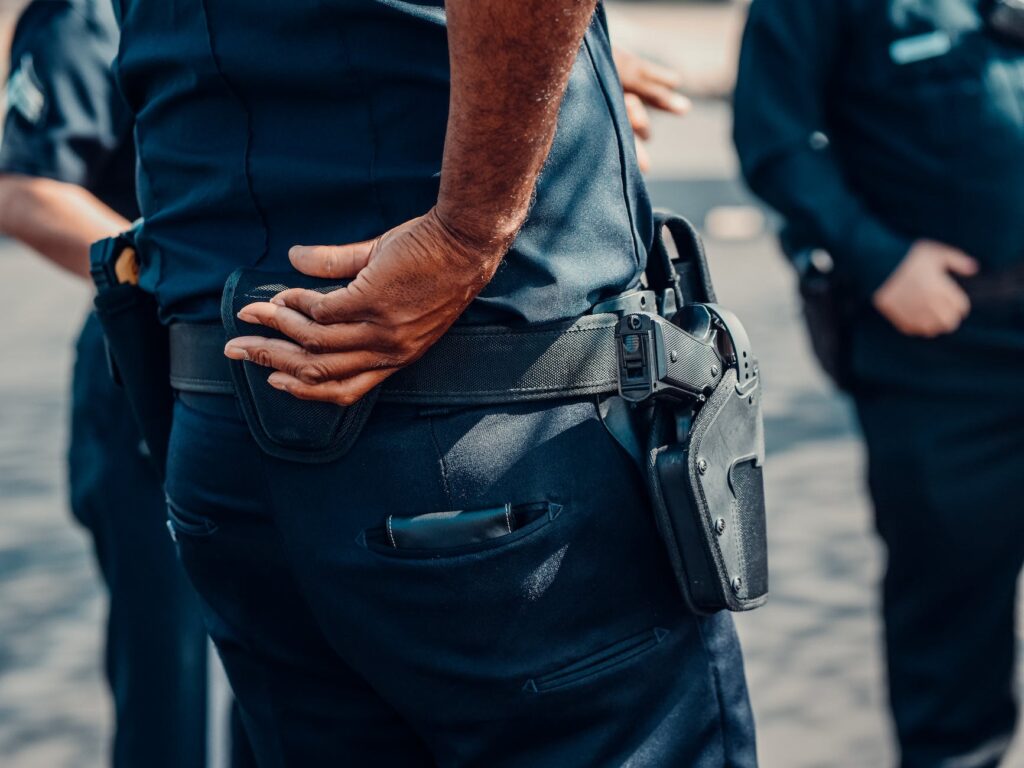 person in blue uniform with a holster
